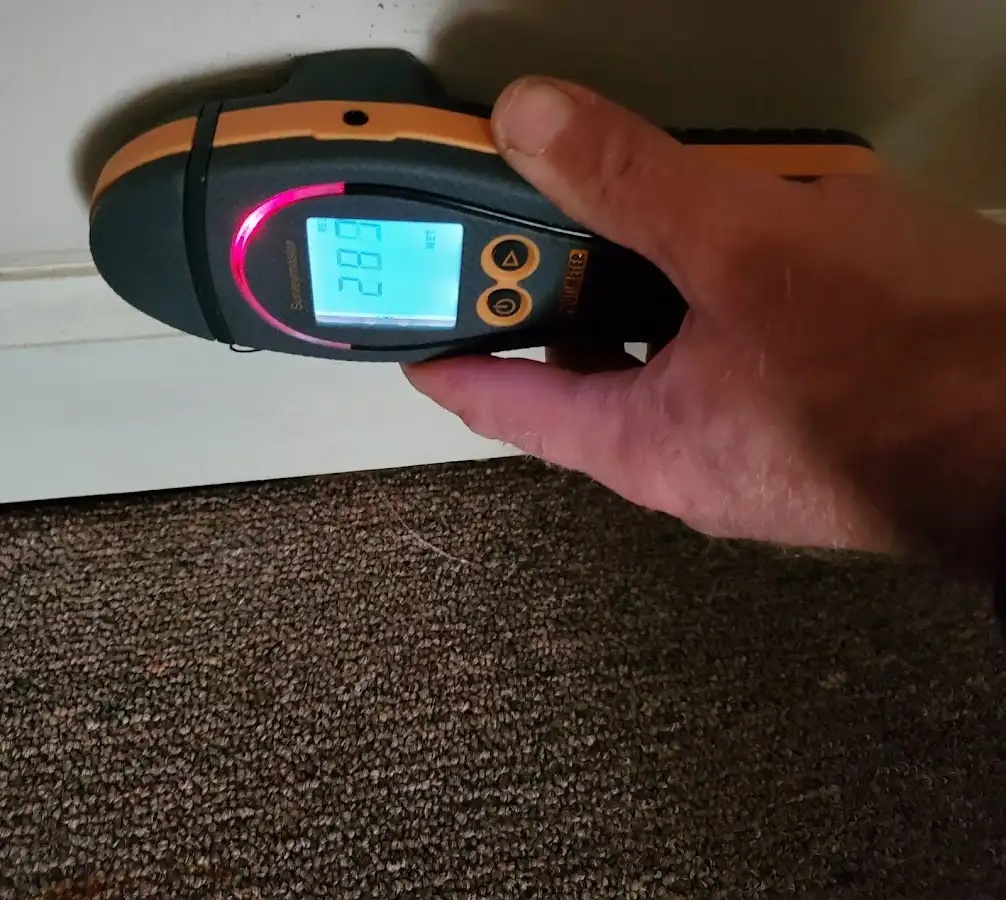 Moisture detection at baseboard during Storm Damage Restoration in Oakdale